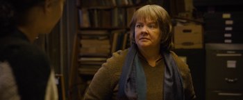 Movie still from “Can You Ever Forgive Me?” (2018), directed by Marielle Heller – A woman in a brown sweater and a blue scarf; Close Up shot, Over the shoulder angle