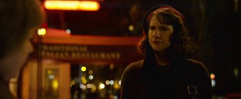 Movie still from “Can You Ever Forgive Me?” (2018), directed by Marielle Heller – A woman standing in front of a building at night; Close Up shot, Low angle