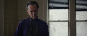 Movie still from “Can You Ever Forgive Me?” (2018), directed by Marielle Heller – An older man in a purple shirt and a green tie; Close Up shot, Over the shoulder angle