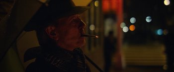 Movie still from “Can You Ever Forgive Me?” (2018), directed by Marielle Heller – An older man wearing a hat and smoking a cigarette; Close Up shot, Low angle