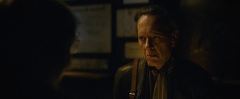 Movie still from “Can You Ever Forgive Me?” (2018), directed by Marielle Heller – An older man with a beard and mustache looking at the camera; Close Up shot, Over the shoulder angle