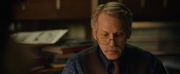 Movie still from “Can You Ever Forgive Me?” (2018), directed by Marielle Heller – An older man wearing glasses and a tie; Close Up shot, Over the shoulder angle