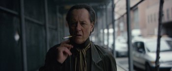 Movie still from “Can You Ever Forgive Me?” (2018), directed by Marielle Heller – A man smoking a cigarette while wearing a leather jacket; Close Up shot, Low angle