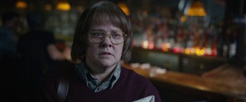 Movie still from “Can You Ever Forgive Me?” (2018), directed by Marielle Heller – A woman wearing glasses and a sweater stares at the camera; Close Up shot, Over the shoulder angle