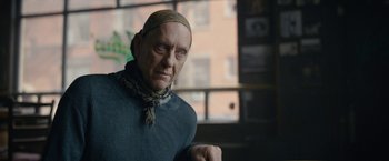 Movie still from “Can You Ever Forgive Me?” (2018), directed by Marielle Heller – An older man wearing a head scarf in front of a window; Close Up shot, Low angle