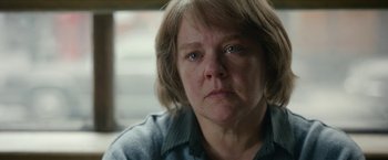 Movie still from “Can You Ever Forgive Me?” (2018), directed by Marielle Heller – An older woman with short brown hair looking sad; Close Up shot, Over the shoulder angle