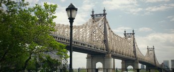 Movie still from “Can You Ever Forgive Me?” (2018), directed by Marielle Heller – A view of a bridge from across the river; Extreme Wide shot, Over the shoulder angle