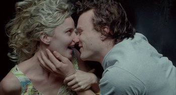 Movie still from “Candy” (2006), directed by Neil Armfield – A man and a woman kissing each other; Close Up shot, Overhead angle