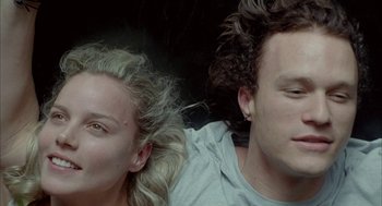 Movie still from “Candy” (2006), directed by Neil Armfield – A man and a woman sitting next to each other on the ground; Close Up shot, Overhead angle