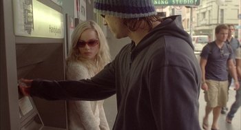 Movie still from “Candy” (2006), directed by Neil Armfield – A man and a woman standing next to each other; Medium shot, Over the shoulder angle