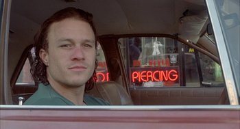 Movie still from “Candy” (2006), directed by Neil Armfield – A man sitting in the back seat of a car; Close Up shot, Over the shoulder angle