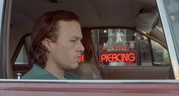Movie still from “Candy” (2006), directed by Neil Armfield – A man sitting in the back seat of a car; Close Up shot, Over the shoulder angle