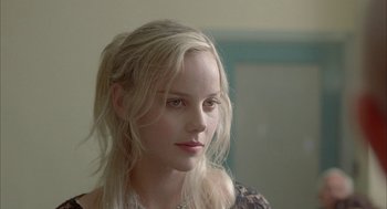 Movie still from “Candy” (2006), directed by Neil Armfield – A beautiful young woman with long blonde hair; Close Up shot, Over the shoulder angle