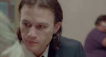 Movie still from “Candy” (2006), directed by Neil Armfield – A person wearing a suit and tie; Close Up shot, High angle