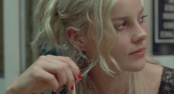 Movie still from “Candy” (2006), directed by Neil Armfield – A young woman is holding her hair up; Close Up shot, Over the shoulder angle