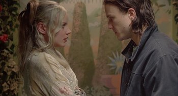 Movie still from “Candy” (2006), directed by Neil Armfield – A man and a woman face to face in front of a painting; Close Up shot, Low angle
