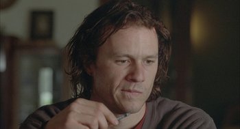 Movie still from “Candy” (2006), directed by Neil Armfield – A person holding a pen; Close Up shot, Over the shoulder angle