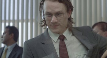 Movie still from “Candy” (2006), directed by Neil Armfield – A person wearing a suit and tie; Close Up shot, Low angle