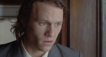 Movie still from “Candy” (2006), directed by Neil Armfield – A person wearing a suit and tie; Close Up shot, High angle