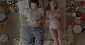 Movie still from “Candy” (2006), directed by Neil Armfield – A man and a woman laying in a bed together; Medium shot, Overhead angle