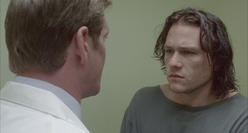 Movie still from “Candy” (2006), directed by Neil Armfield – A man looking at a man in the mirror; Close Up shot, Over the shoulder angle