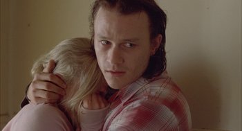 Movie still from “Candy” (2006), directed by Neil Armfield – A man holding a woman in his arms; Close Up shot, Over the shoulder angle