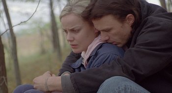 Movie still from “Candy” (2006), directed by Neil Armfield – A man and a woman sitting next to each other on the ground; Close Up shot, Low angle