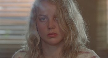 Movie still from “Candy” (2006), directed by Neil Armfield – A person with blonde hair; Close Up shot, Over the shoulder angle