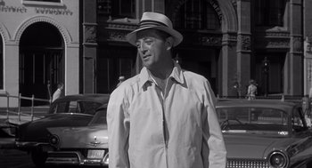 Movie still from “Cape Fear” (1962), directed by J. Lee Thompson – A black and white photo of a man wearing a hat; Medium shot, Over the shoulder angle