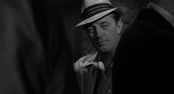 Movie still from “Cape Fear” (1962), directed by J. Lee Thompson – A black and white photo of a man wearing a hat; Close Up shot, Over the shoulder angle