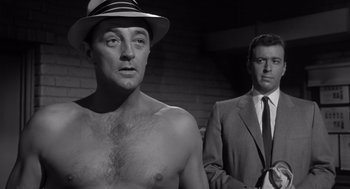 Movie still from “Cape Fear” (1962), directed by J. Lee Thompson – A man in a hat and a man in a suit; Medium shot, Low angle