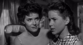 Movie still from “Cape Fear” (1962), directed by J. Lee Thompson – A woman standing next to a young boy; Close Up shot, Over the shoulder angle