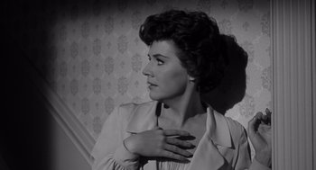 Movie still from “Cape Fear” (1962), directed by J. Lee Thompson – A black - and - white photo of a woman with her hand on her chest; Close Up shot, Low angle
