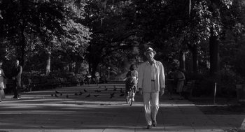 Movie still from “Cape Fear” (1962), directed by J. Lee Thompson – An older man walking down the street with a hat on; Wide shot, Low angle