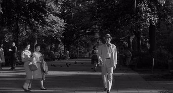 Movie still from “Cape Fear” (1962), directed by J. Lee Thompson – An older man walking down the street with a hat on; Wide shot, Low angle