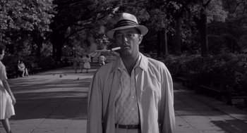 Movie still from “Cape Fear” (1962), directed by J. Lee Thompson – A black and white photo of a man smoking a cigarette; Medium shot, Low angle