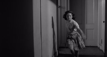 Movie still from “Cape Fear” (1962), directed by J. Lee Thompson – A young girl running in front of a wall; Medium shot, High angle