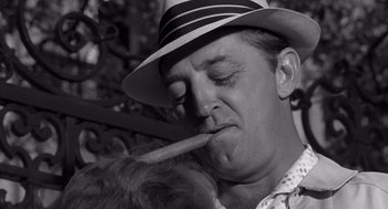 Movie still from “Cape Fear” (1962), directed by J. Lee Thompson – A black and white photo of a man smoking a pipe; Close Up shot, Low angle