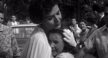 Movie still from “Cape Fear” (1962), directed by J. Lee Thompson – An old photo of a woman and a little girl; Medium shot, Low angle