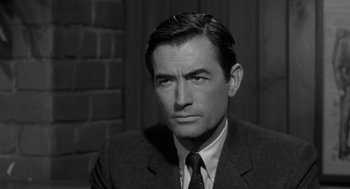 Movie still from “Cape Fear” (1962), directed by J. Lee Thompson – Black and white photograph of a man wearing a suit and tie; Close Up shot, High angle