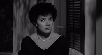 Movie still from “Cape Fear” (1962), directed by J. Lee Thompson – A black and white photo of a woman in a black dress; Close Up shot, Over the shoulder angle