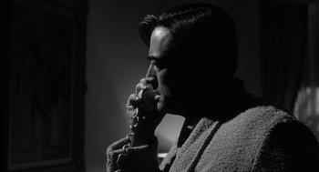 Movie still from “Cape Fear” (1962), directed by J. Lee Thompson – A black and white photo of a man talking on a phone; Close Up shot, Low angle