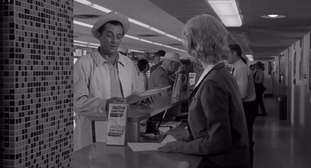 Movie still from “Cape Fear” (1962), directed by J. Lee Thompson – A man and a woman are talking at a counter; Medium shot, Low angle