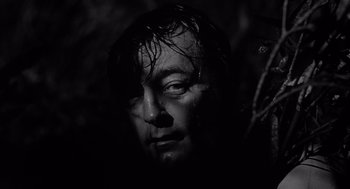 Movie still from “Cape Fear” (1962), directed by J. Lee Thompson – A black and white photo of a man's face; Close Up shot, Low angle