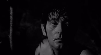 Movie still from “Cape Fear” (1962), directed by J. Lee Thompson – A young man with wet hair stares into the camera; Close Up shot, Low angle