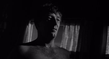 Movie still from “Cape Fear” (1962), directed by J. Lee Thompson – A black and white photo of a man's face; Close Up shot, Low angle