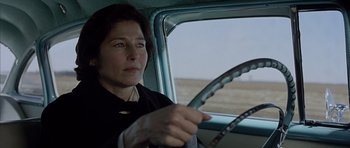 Movie still from “Capote” (2005), directed by Bennett Miller – A woman sitting in the driver's seat of a car; Close Up shot, Over the shoulder angle