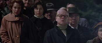 Movie still from “Capote” (2005), directed by Bennett Miller – A group of people standing next to each other; Medium shot, Over the shoulder angle