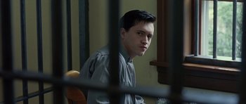 Movie still from “Capote” (2005), directed by Bennett Miller – A man sitting in front of a jail cell; Close Up shot, Over the shoulder angle