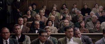 Movie still from “Capote” (2005), directed by Bennett Miller – A group of people sitting in front of a judge; Wide shot, High angle